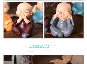 Detail of four colorful monk figurines with matte resin texture on a wooden background