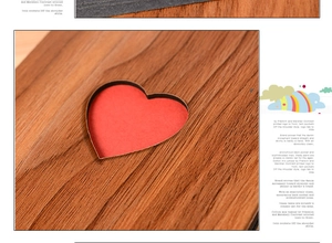 Macro shot of 6-inch wooden photo album cover with heart cutout and red inner liner