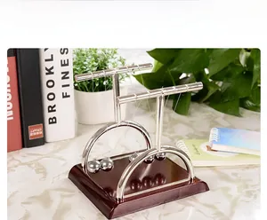 Detailed close-up of metal spheres and curved supports on a Newton's Cradle base