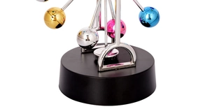 Macro-opname van kleurrijk kinetisch reuzenrad met metalen bollen en zwarte standaard