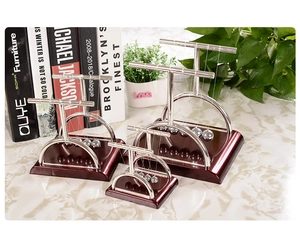 Comparison of four different sizes of T-shaped Newton's cradle balance ball desk ornaments