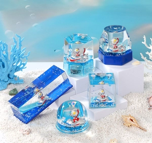 Macro detail of acrylic liquid hourglass featuring cartoon hero and blue sea theme
