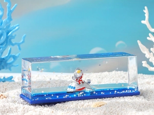 Macro view of blue liquid hourglass with a miniature figure in a clear acrylic case