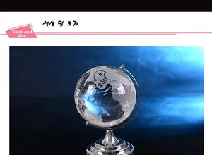 Detailed view of clear crystal globe with world map on a silver tiered metal base