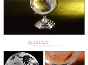 Macro detail of high-transparency crystal globe with engraved map and silver metal base