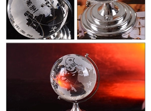 Close-up of clear crystal globe with etched continents and polished metal tiered base