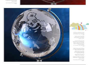 Detail of crystal globe ornament with silver metal stand and etched geographical map