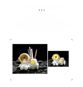 Close-up of astronaut night light and pen holder desk organizer with moonlight glow