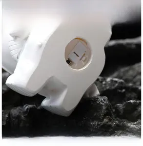 Detailed base of the resin night light showing the battery compartment and power switch