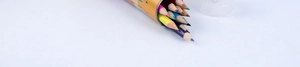 Detail of 12 short colored pencils with sharpened tips in a yellow cylindrical case