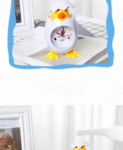 Close-up of cute cartoon chick alarm clock with eggshell design and yellow chicken feet