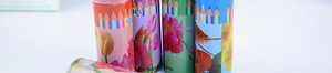 Detail view of flower patterns and brand logo on the cylindrical coloring pencil tube