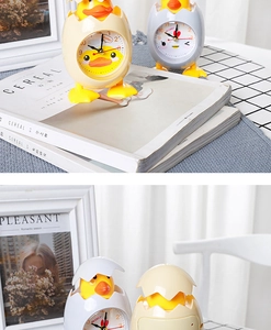 Close-up of chick-shaped alarm clock showing clear dial and creative eggshell design