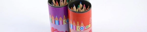Close-up of two cylindrical tubes containing a variety of 12 vibrant colored pencils