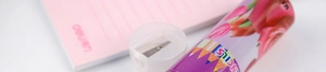 Close-up of purple tulip pencil holder with pencils text and clear pencil sharpener
