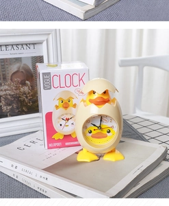 Detail of creative yellow chick alarm clock with eggshell design in colorful packaging