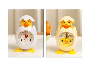 Detailed dial of cartoon chick alarm clock with two color options and cute expressions