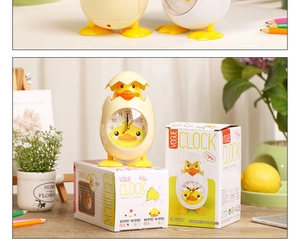 Close-up of yellow chick alarm clock with its colorful retail packaging and light function