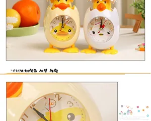 Detail view of cartoon chick desk clocks in yellow and white with cute eggshell design
