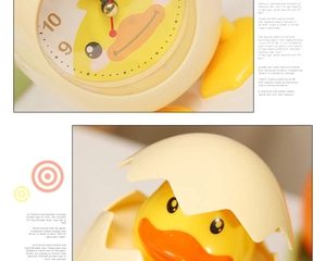 Detail of yellow cartoon chick desk clock and hatching duckling figurine for kids