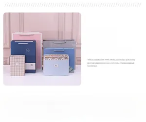 Detailed close-up of cartoon gift bags with woven handles and My Queen typography