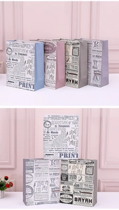 Close-up of vintage style gift bags with antique newspaper patterns and sturdy handles