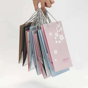 Pastel Sakura floral paper gift bags set with woven handles in multiple colors