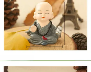 Close-up of a small monk figurine in a grey robe with dimensions 5.7cm by 5.5cm