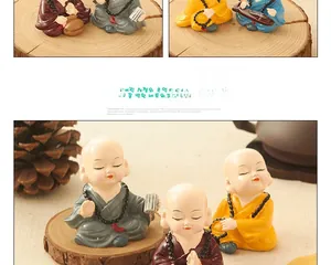 Detail of four resin kung fu monk figurines in colorful robes for zen car interior decor