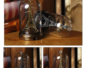 Close-up of vintage Eiffel Tower glass dome with warm LED copper string lights