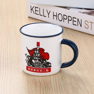 Retro ceramic mug with red revolutionary art and blue rim on a wooden table surface