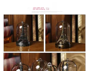 Macro detail of Eiffel Tower glass dome night light with warm LED string light