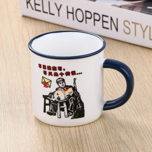 Close-up of retro ceramic mug with blue handle and vintage illustration on wooden desk