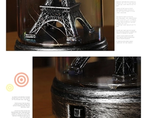 Macro detail of Eiffel Tower lamp with metal wire lights in cylindrical glass cover