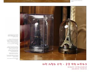 Eiffel Tower glass dome LED lights with bronze and black bases on wooden table