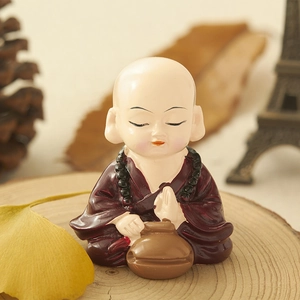 Zen little monk resin ornament for car or home decor, peaceful sitting pose on wood