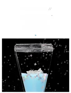 Close-up of starry universe oil drop hourglass with spaceship and blue liquid glitters