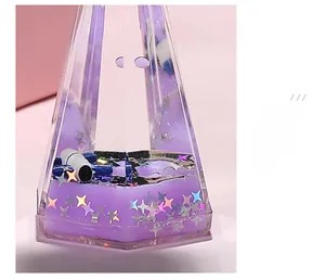 Detail of purple liquid star hourglass with floating glitters and mechanical decor