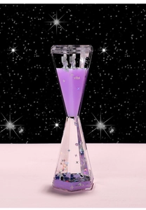 Detail of purple floating astronaut liquid hourglass with shimmering star sequins