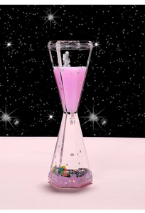 Macro view of floating astronaut in pink liquid timer with star glitter accents