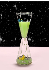 Detail view of astronaut sensory liquid timer with green fluid and floating moon
