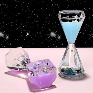 Diamond-shaped liquid timer hourglass with cosmic glitter and miniature earth decor