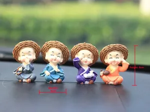 Detail view showing four resin monks with straw hats and colorful robes, 6cm in height