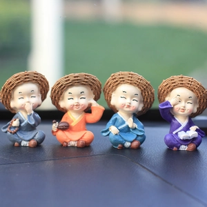 Set of four resin monk figurines with straw hats for creative car dashboard decoration