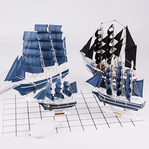 Detailed close-up of three vintage wooden sailing boat models in blue and white theme