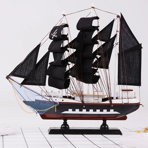 Classic wooden pirate ship model with black sails and skull flag for home decor