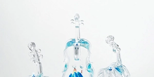 Detailed macro view of transparent violin-shaped ornament with blue oil and ocean theme