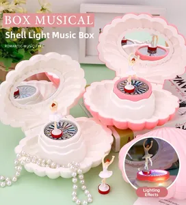 Detail of shell music box featuring a ballet dancer figure, mirror and led lighting