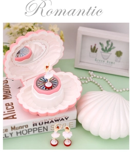 Detail of shell musical jewelry box with rotating ballerina and inner mirror for girls