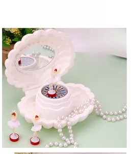 Detail of shell jewelry music box with ballerina figurine and interior vanity mirror